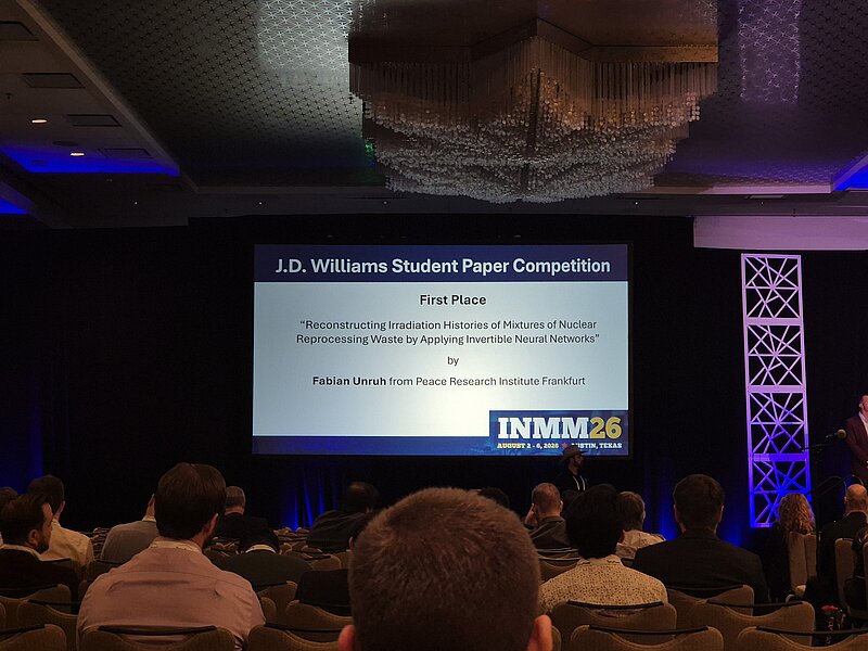 Slide during the Awarding Ceremony announcing the first place in the J.D. Williams Student Paper Competition for Fabian Unruh for his Paper "Reconstructing Irradiation Histories of Mixtures of Nuclear Reprocessing Waste by Applying Invertible Neural Networks"