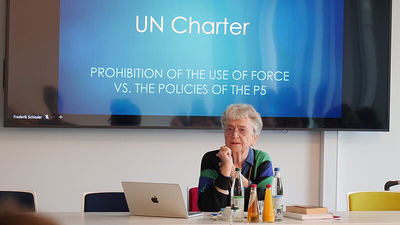 Kerstin Leitner; the presentation slide "UN Charter" and PRIF audience in background
