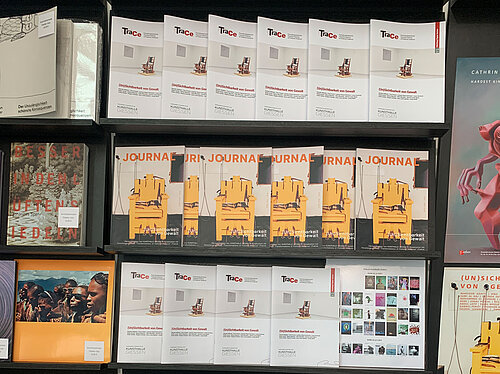 The journal and the TraCe Working Paper are displayed on a showcase shelf.